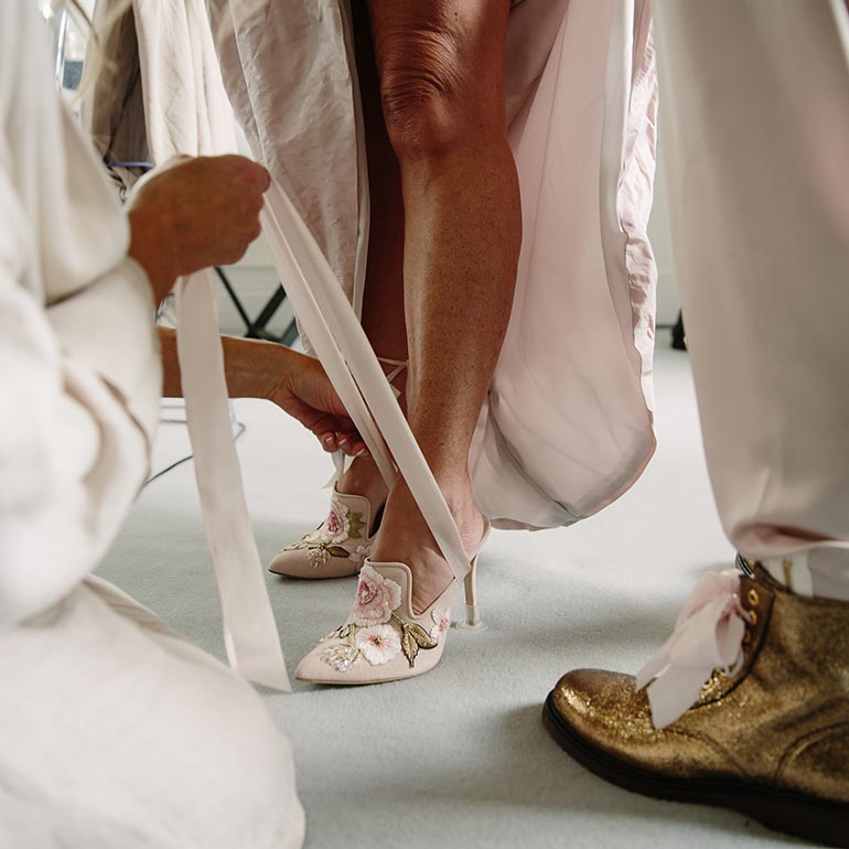 Wedding shoes being tied
