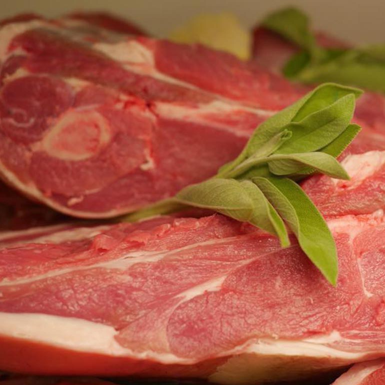 Raw cuts of meat with sage leaves