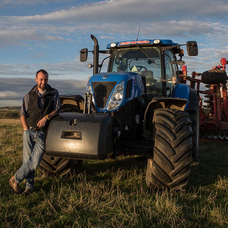 Lady standing by tractor