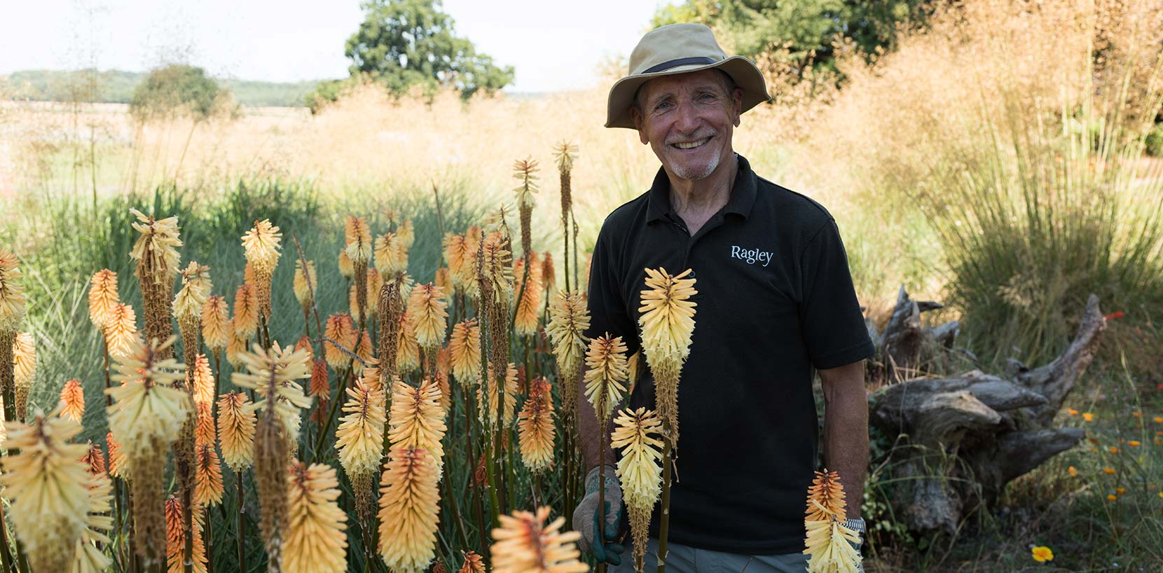 Gardener standing next to flowers at Ragley Hall