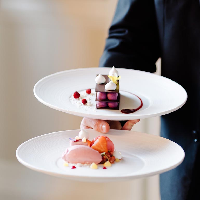 Waiter serving desserts